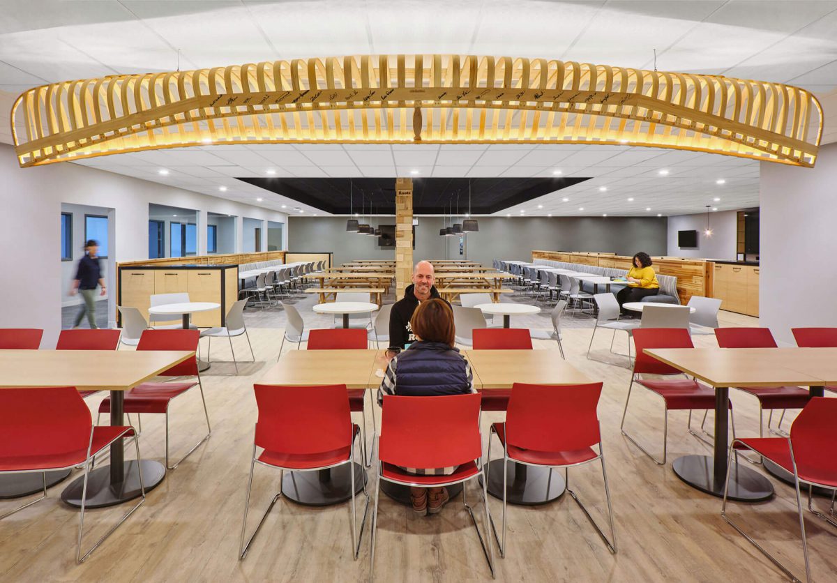 Roots Cafe with Wood Laminate Tables and Red Seating