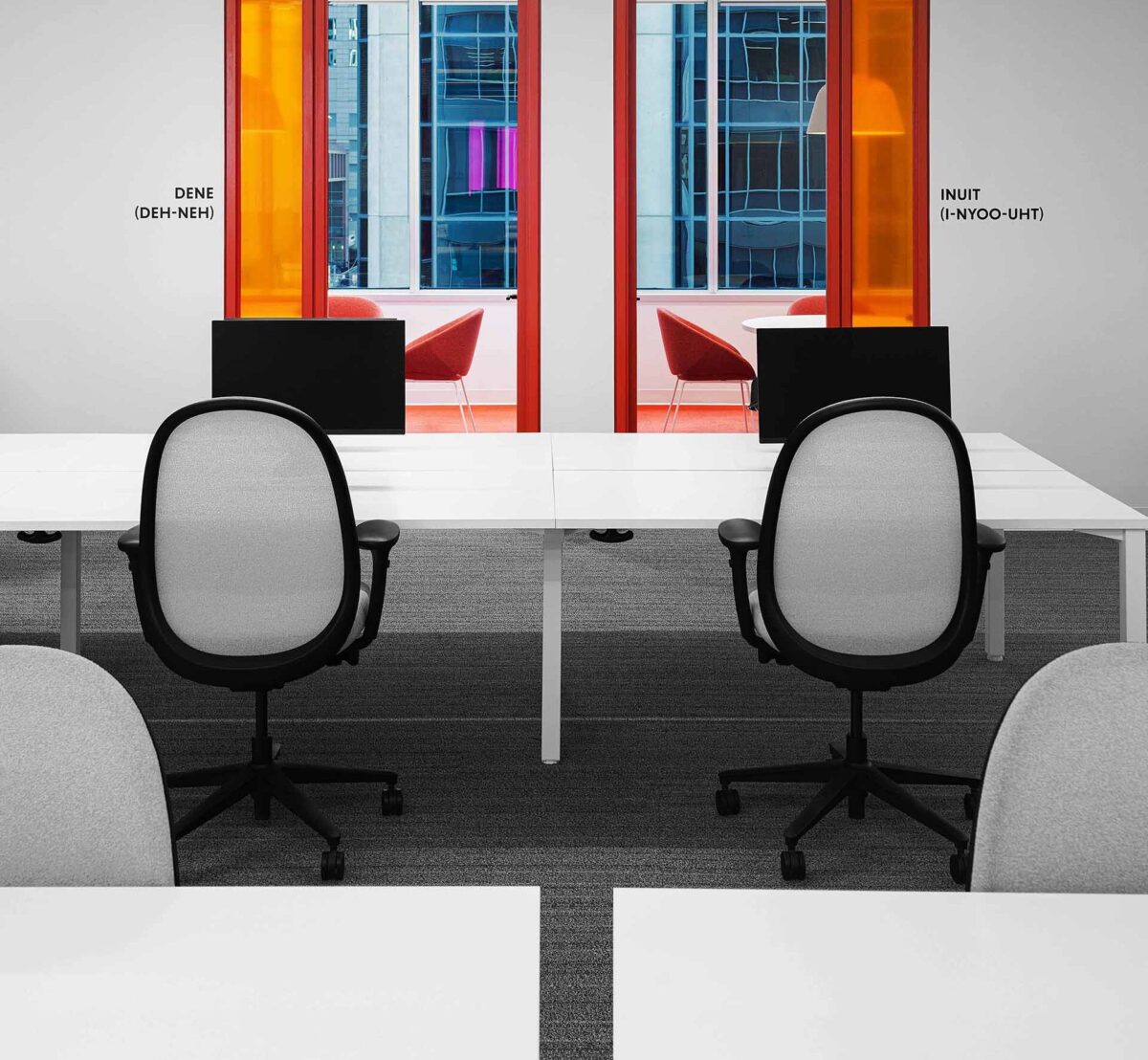 Collaborative workspace with large white desk and Teknion Tone chairs.
